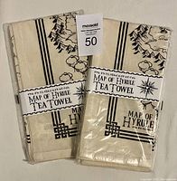 Two folded and packaged Legend of Zelda Map of Hyrule tea towel sets viewed from front showing title label and partial map design