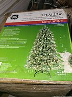 Box of 7 Foot Pre-Lit Cashmere Pine Artificial Christmas Tree with green package showing image of tree and product info.