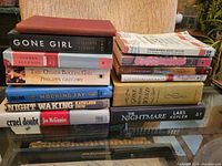 Photo of all 13 books stacked in two piles showing titles and conditions