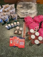 Full view of assorted items including Olay lotions, nail polishes, lip balms, pink bath poufs, mini bubble bath bottles, makeup bags, glitter pot, and ruler.