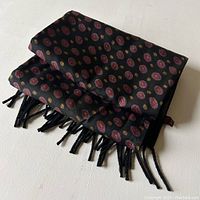 Folded view of scarf showing patterned silk side and fringed ends