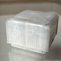 Side and bottom view showing the celluloid material, box shape, and underside marking.