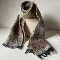 Full view of scarf draped to show colors and texture, fringed ends visible