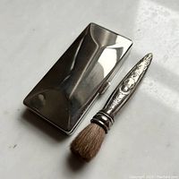 Silver plate rectangular compact and matching soft sable brush with engraved silver handle.