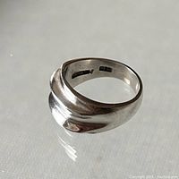 View of sterling silver modernist ring showing raised curved ridge detail and polished finish