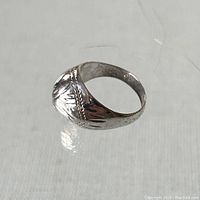 Clear photo of the sterling silver domed ring showing its side profile and etched design.