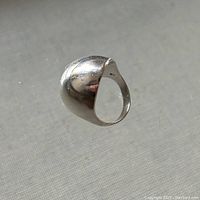 Clear image showing the side view of the sterling silver hollow domed ring, highlighting the curved design and reflective surface.