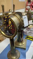 Overall view of brass ships engine telegraph on base and marine compass together