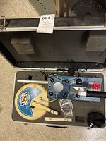 Metal detector components including control unit and coil inside carry case, showing overall condition and layout.