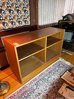 Front and side view of teak shelf showing its overall structure and compartment divisions.