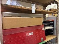 Red Craftsman tool chest on metal shelving unit with label 663 above