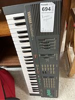 Full view of Yamaha PortaSound keyboard showing keys, Yamaha branding, PortaSound PSS-480 model name, and various control sliders and buttons on top panel.