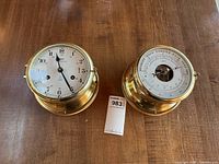 Pair of instruments, clock on left, barometer on right