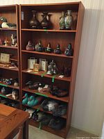 Front view of tall bookshelf loaded with items