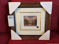 Front view of the framed Black Spruce print with protective corner covers and a MaxSold lot number tag