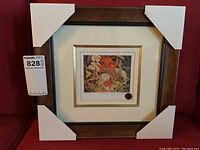 Framed view of the numbered print 'Flowers' by Tom Thomson with protective corners on the frame.