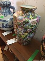 View of the vase showcasing the colorful floral pattern and body shape