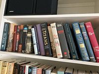 Books on shelf including titles by Pierre Berton, Peter Newman, Bob Woodward and others.