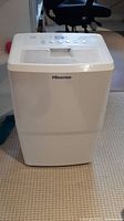 Front view of white Hisense dehumidifier showing brand logo and top control panel.