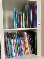 Photo showing two shelves with a variety of travel and gardening books arranged upright, covers visible with colorful spines.