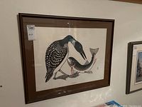 Framed print showing the full artwork of a loon holding a fish, labeled with a MaxSold tag.