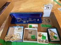 Photo of the lot showing charm bracelet in Normandy blue case, pearl necklace and bracelet, various chains, earrings, and brooch.