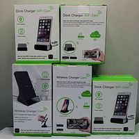 Front view of three Dock Charger WiFi Cam boxes (left and right) and two Wireless Charger Cam boxes (center).