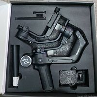 FeiyuTech SCORP-C 3-axis gimbal in original foam packaging with mounting plate and handle