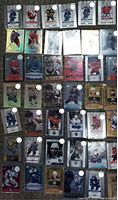 Grid of 30+ hockey cards laid out on carpet, showing various Game Day Gold base parallels