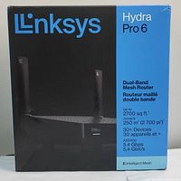 Front of the box showing the product image, brand Linksys, model Hydra Pro 6, dual-band mesh router, coverage up to 2700 sq ft, supports 30+ devices, AX5400 standard, 5.4 Gbps speed.