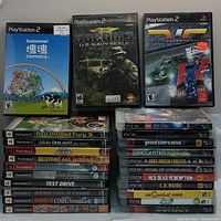 Multiple PlayStation 2 and PlayStation 3 game cases stacked