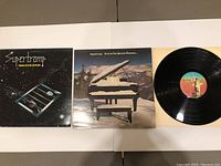 Front covers and vinyl record for two Supertramp albums visible showing artwork and record condition.