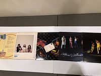 Five Max Webster vinyl records laid out, fronts of album covers visible showing band photos and various artwork designs.