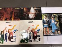 Five ABBA album covers and record sleeves visible, showing condition and artwork of albums in the lot.
