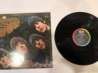Front cover of The Beatles Rubber Soul vinyl record, still in plastic shrink wrap, showing the band members and title.