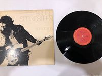 Front of Bruce Springsteen Born To Run vinyl album cover and the vinyl record with red label.