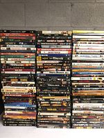 Large stack of DVDs including Casino Royale, Henry V, Ghost World, Gran Torino, and more.