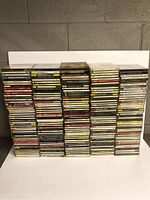 Large stacks of jewel case CD spines showing classical and various composers