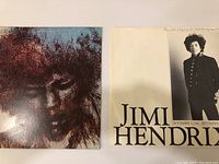 Photo showing front and back of album cover, front features artistic portrait of Jimi Hendrix, back lists name and dates with partial text.