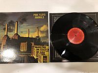 Front cover of Pink Floyd Animals vinyl album showing iconic Battersea Power Station artwork with floating pig.