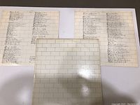 Front and back side of lyric inserts showing handwritten style font lyrics on a white brick wall pattern background