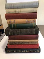 Stack of 10 hardcover books showing spines and partial covers, titles visible include 'The Thirty-Nine Steps', 'Once an Eagle', 'Treasures of Britain' among others.