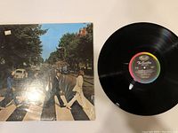 Front cover photo of Abbey Road vinyl album with all four Beatles crossing the street.