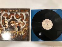 Front cover and vinyl record photo showing The Cult Electric vinyl album with band image on cover and disc label.