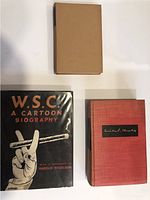 Photo showing three hardcover books, one with dust jacket 'W.S.C. A Cartoon Biography', one red cloth hardcover book with signature plaque, and one plain hardcover book.