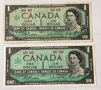 Two Canadian Centennial one dollar bills front side showing Queen Elizabeth II portraits and dated '1867-1967'.