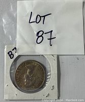 Obverse side of the 1958 Canadian fifty cent coin showing Queen Elizabeth II profile with inscription around the edge.