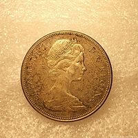 Obverse side of the 1967 Canadian silver dollar showing Queen Elizabeth II and inscriptions.