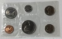 Front view of first 1968 Canadian coin set with seven coins in clear plastic casing, showing Queen Elizabeth II on obverse and various Canadian designs on reverse.