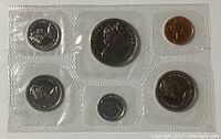 Front view of 1970 Canadian coin set in sealed plastic holder, showing seven coins of various sizes including a large silver coin, smaller silver coins and a copper cent coin.